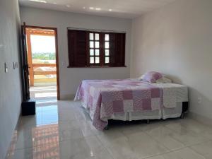ein Schlafzimmer mit einem Bett in der Ecke eines Zimmers in der Unterkunft Casa Malta - St Sul in Goiânia