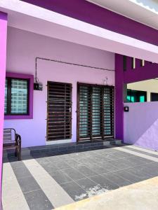 a purple building with windows and a bench at RAINA MUSLIM FRIENDLY HOMESTAY Perlis in Arau