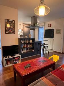 a living room with a table in the middle of a room at Spacious & cosy flat in Massy
