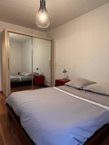 a bedroom with a large bed with a large mirror at Spacious & cosy flat in Massy