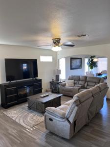 uma sala de estar com um sofá e uma televisão em Spacious, comfortable & relaxing home 4 em Las Cruces