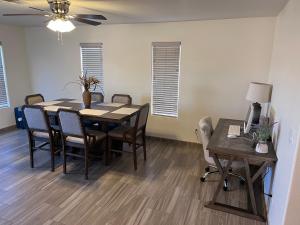 a dining room with a table and chairs and a desk at Spacious, comfortable & relaxing home 4 in Las Cruces