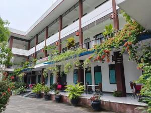 a building with plants on the side of it at Thuy Loi Hotel in Hoi An