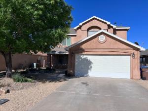 a garage door on a house with a tree at Spacious, comfortable & relaxing home 4 in Las Cruces