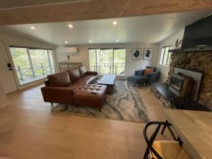 a living room with a couch and a fireplace at The River House in Grants Pass