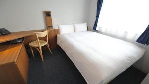 a small room with a bed and a desk and a desk at Toyoko Inn Tokyo Haneda Airport No.2 in Tokyo