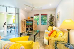 a living room with a couch and a table at Oasis 8 at Palm Cove in Palm Cove