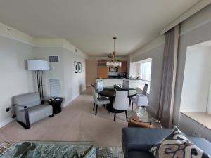 a living room with a table and a dining room at 2 Bedroom OR King Studio Suites Four Seasons Hotel Miami Free Wi-Fi & Free Parking in Miami