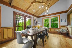 a dining room with a large wooden table and chairs at Chic private cabin w/ epic views & amenities! in Cove Creek Cascades