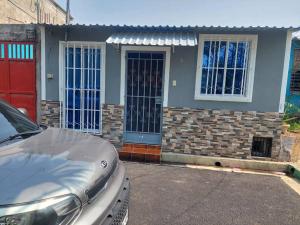 a house with a car parked in front of it at Yanira's house in Santa Ana