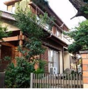 a house with a fence in front of it at "Cherry House" is Direct to Narita,Haneda AP, Disney, Asakusa, Skytree Tower, Tokyo in Matsudo