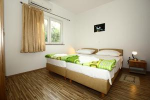 Postel nebo postele na pokoji v ubytování Apartments Vesna