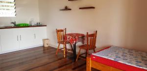 a small kitchen with a table and two chairs at Seachange Lodge in Port Vila