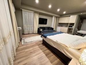 a bedroom with a large bed and a couch at Avenue guest غرف فندقية in Buyukcekmece