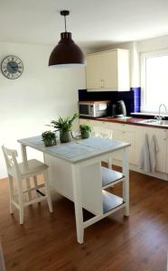 a kitchen with a table and two chairs and a table and a table at Horsea 