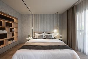a bedroom with a large bed and a large window at WiSmart in Taichung