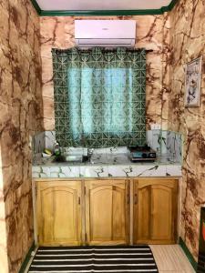 a bathroom with a sink and a window at Noah Xye Guest House in San Juan +30 photos