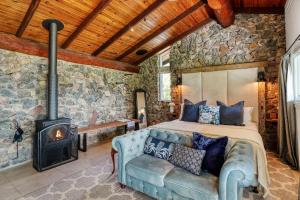 a bedroom with a bed and a wood stove at Maleny Country Estate in Maleny
