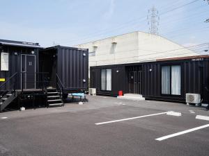 a group of shipping containers in a parking lot at HOTEL R9 The Yard Kaizu in Kaizu