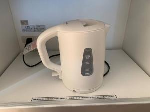 a white appliance sitting on top of a counter at 木漏れ日ハウス in Karuizawa