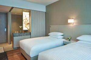 a hotel room with two beds and a window at Courtyard by Marriott Singapore Novena in Singapore