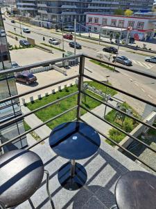 a blue chair on a balcony with a view of a city at Mihail apartament in Năvodari