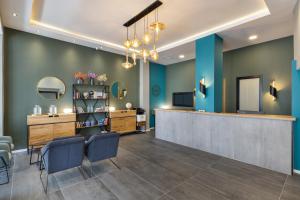 a salon with blue walls and a waiting room at Residence Suites BY RAPHAEL HOTELS in Tel Aviv