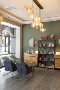 salon z krzesłami, stołem i półką na książki w obiekcie Residence Suites BY RAPHAEL HOTELS w Tel Awiwie