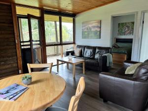 a living room with a couch and a table at Happy Wanderer Holiday Resort The Grampians in Wartook