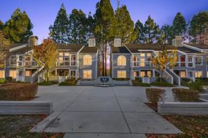 a large blue house with trees in front of it at Luxurious 2-bedrooms in Redwood + free parking in Redwood City