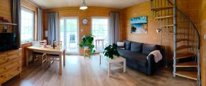a living room with a couch and a table at Agroturystyka - Stajnia Bursztynowa in Puck