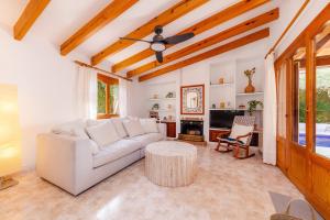 een woonkamer met een witte bank en een tafel bij Na Forana Cala Ratjada in Cala Ratjada