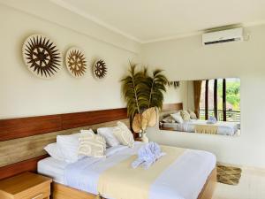 una camera da letto con due letti e uno specchio di Pillow Inn Ubud ad Ubud
