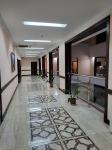 an empty hallway with potted plants in a building at seoul hotel in Shymkent