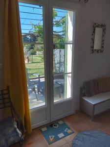 a living room with a sliding glass door at Gite La RESTANCO in Mouriès +10 photos