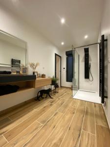 a bedroom with a wooden floor and a glass wall at **** Le Patio **** aux portes de Chambord in Crouy-sur-Cosson