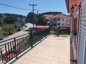 a balcony with a black fence and a sidewalk at Villa Roxa Montuoso in Agios Leon