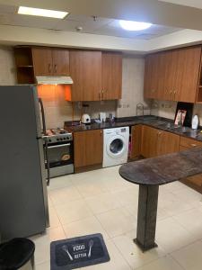 a kitchen with a washer and dryer in it at Sahara private apartment in Dubai