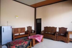a room with wooden furniture and a refrigerator at RedDoorz Syariah near Flyover Palur in Karanganyar