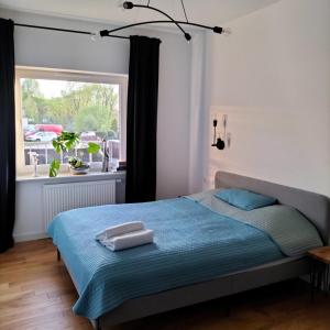 a bedroom with a bed with two towels on it at Apartament Słoneczny 2 in Sanok