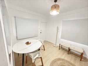 a white room with a white table and a chair at Gladstone Gem 3 - Suva CBD 2bd Apt in Suva