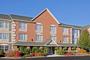 a large brick building with flowers in front of it at Country Inn & Suites by Radisson, Macedonia, OH in Macedonia