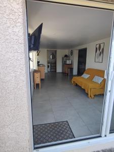 a view of a bedroom with a bed and a living room at Gîte la Pradelienne en Cévennes avec piscine privée 