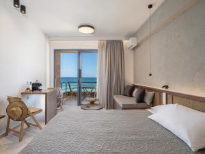 a hotel room with a bed and a view of the ocean at Nais Apartments & Studios in Chania