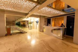 a lobby with a staircase and a reception desk at Hotel Hardeo in Nagpur