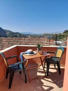 a table and chairs on a balcony with a view at Thea's country house in Aryiroúpolis