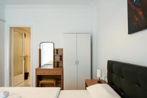 Ένα ή περισσότερα κρεβάτια σε δωμάτιο στο Thessaloniki Center Deluxe Apartment
