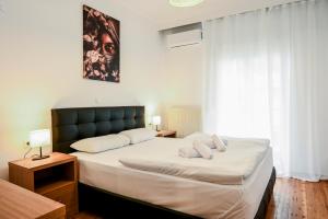 a bedroom with a large bed with two pillows on it at Thessaloniki Center Deluxe Apartment in Thessaloniki