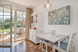 a kitchen with a table and chairs and a dining room at Landhaus Krummin in Krummin