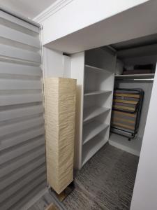 a walk in closet with a wooden cabinet in it at Eduard House Room in Ungheni
